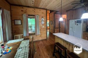 a kitchen in a log cabin with a counter top at Tree Top Hideaway - Private with Games Firepit More in Blue Ridge