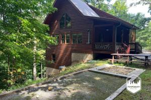 a log cabin with a picnic table in front of it at Tree Top Hideaway - Private with Games Firepit More in Blue Ridge