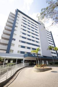 a large white building with a courtyard in front of it at Transamerica Executive Belo Horizonte in Belo Horizonte