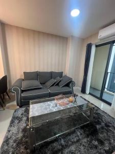 a living room with a couch and a coffee table at 501B #1km to central festival #5 km to lee garden in Ban Khlong Wa +21 photos