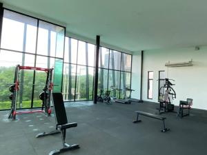 a gym with treadmills and machines in a building at 501B #1km to central festival #5 km to lee garden in Ban Khlong Wa