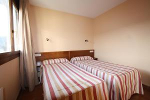 Postel nebo postele na pokoji v ubytování Apart-Hotel Selva Nevada