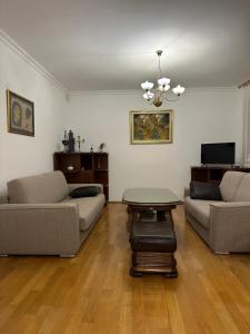 a living room with two couches and a table at Royal Apartment in Banja Luka