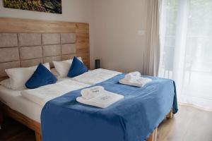 Posteľ alebo postele v izbe v ubytovaní Apartamenty Pruskie