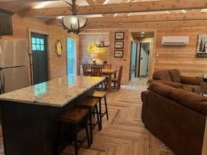 a kitchen and living room in a log cabin at Cozy Cabin Retreat for Your Perfect Getaway in Imperial
