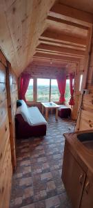 a large room with two beds and a table in it at Markove kolibe 5, Uvac, Sjenica in Sjenica