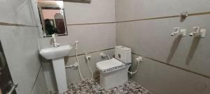 a bathroom with a toilet and a sink at Shree Gopal Niketan in Mathura +43 photos