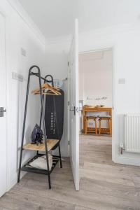 a room with a shelf and a table in a room at Stylish one bedroom garden suite in Winsford