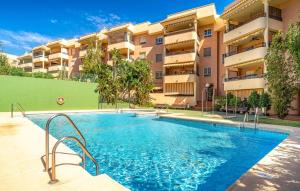 a swimming pool in front of a building at Nice Apartment In Aguadulce With Wifi in Aguadulce