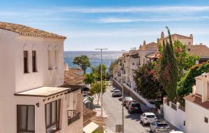 a city street with buildings and the ocean in the background at Nice Apartment In Aguadulce With Wifi in Aguadulce +18 photos