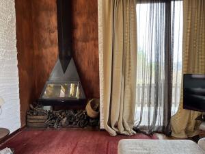 a living room with a fire place in the wall at Cal Fraguerau in Ulldemolins