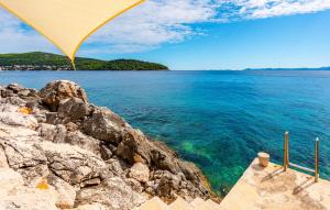 a view of the ocean from a beach with an umbrella at Villa Grandiosa in Blato