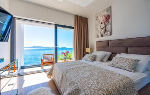 a bedroom with a bed with a view of the ocean at Villa Grandiosa in Blato +37 photos