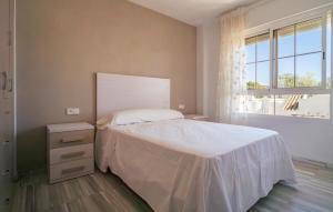 a bedroom with a white bed and a window at Nice Apartment In Aguadulce With Wifi in Aguadulce