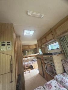 an interior view of an rv with a kitchen and a bedroom at Casa anca in Lunca
