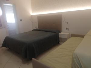 Postel nebo postele na pokoji v ubytování B&B Metropols Sottomarina