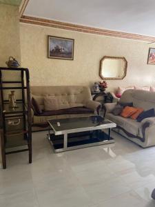 a living room with two couches and a coffee table at Appartement Belevédère in Casablanca