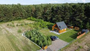 an aerial view of a cabin in the middle of a field at Domek przy lesie na Roztoczu in AdamÃ³w