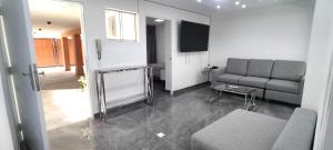 a living room with a couch and a television at El Polo Surco in Lima