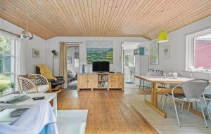 a living room with a wooden ceiling at Holiday Home Strandvej F in Eskebjerg
