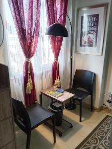 a room with a table and two chairs and a window at Condo for Rent Cheer Residences in Marilao