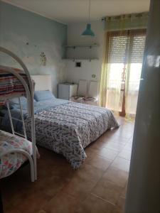 a bedroom with a bed and a tiled floor at Casa mia in Giulianova