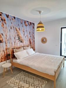 a bedroom with a bed and a wall mural at Studio near Airport & Therme Wellness SPA in Otopeni
