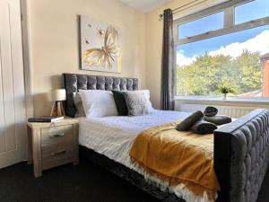a bedroom with a bed with a butterfly on it at Stylish 3-bed home in Prestwich with free parking in Manchester +13 photos