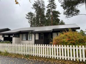 a small house behind a white picket fence at Saukonkatu in Kokkola