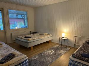 a bedroom with two beds and a window at Saukonkatu in Kokkola