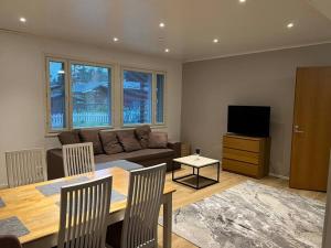 a living room with a table and a couch at Saukonkatu in Kokkola