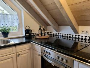 a kitchen with a sink and a stove top oven at Dachgeschosswohnung im Grünen in Waldshut-Tiengen