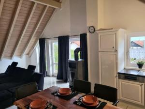 a living room with a table and a stove at Dachgeschosswohnung im Grünen in Waldshut-Tiengen