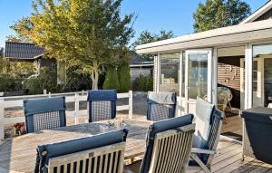 a patio with chairs and a table on a deck at 2 Bedroom Nice Home In Haderslev in Haderslev +10 photos