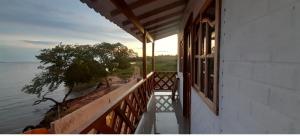 a balcony of a house with a view of the water at Cabaña Barbacoas in Santa Ana +15 photos