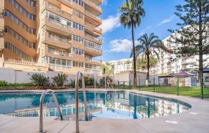 a swimming pool in front of a apartment building at Gorgeous Apartment In Fuengirola in Fuengirola +7 photos