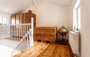 a room with a staircase and a wooden floor at Koje in Heringsdorf +16 photos