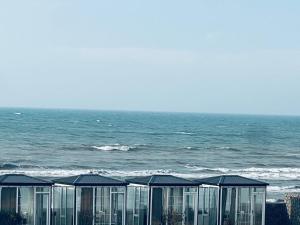 a group of glass buildings next to the ocean at BAKU outskirt - Vacation Home in Baku