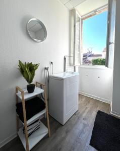 a bathroom with a washing machine and a window at Myvi cognac in Cognac +13 photos
