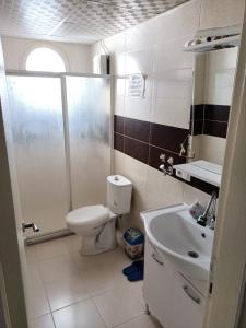 a bathroom with a shower and a toilet and a sink at Egepar Rezidance Apart otel in Buca