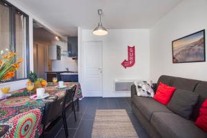 a living room with a couch and a table at Appartement Mazagran - Welkeys in Biarritz