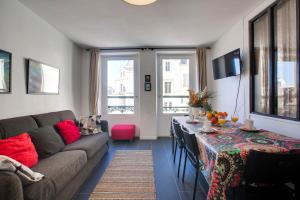 a living room with a couch and a table at Appartement Mazagran - Welkeys in Biarritz