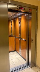 an elevator with wooden doors in a building at Balcon Vue Panoramique - Parking - Gare 200m in Vienne