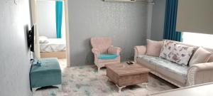 a living room with a couch and a chair at Egepar Rezidance Apart otel in Buca +6 photos