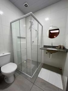 a bathroom with a shower with a toilet and a sink at Suíte Com Vista Privilegiada poucos minutos Vila Germânica Oktoberfest in Blumenau