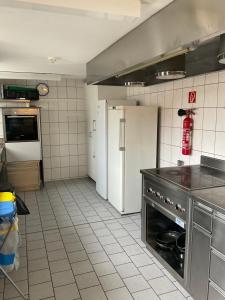 a kitchen with a refrigerator and a stove at 22 - Gästehaus Erika - Hundwil - Appenzellerland in Hundwil