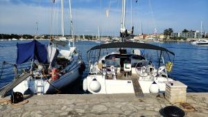 a boat is docked at a dock in the water at Bavaria C42 in Izola +3 photos