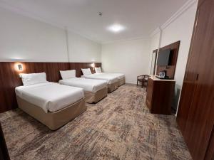 Postel nebo postele na pokoji v ubytování Palestine Hotel Makkah