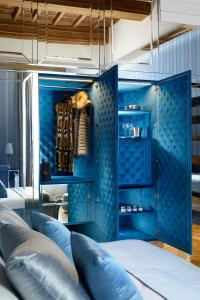 a blue room with a bed and a blue wall at Lifestyle Suites Rome in Rome