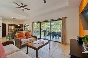 a living room with a couch and a table at Garden Pool & 5-minutes Walk to Beach in Potrero